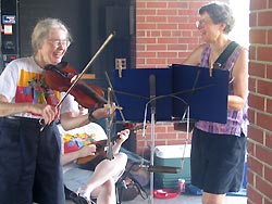 Smiling fiddle and guitar players